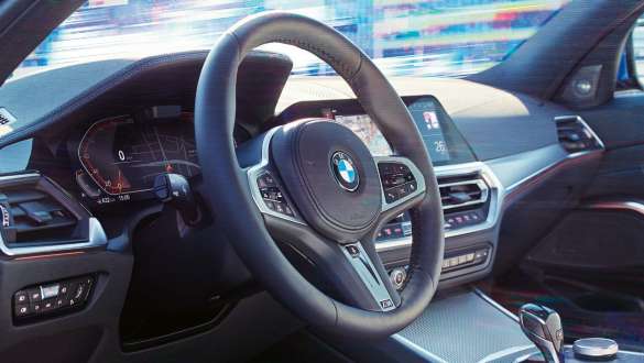 BMW 3 Series Sedan, Variable sport steering. Detailed side view of the cockpit of the BMW 3 Series Sedan with focus on the steering wheel with variable sport steering.