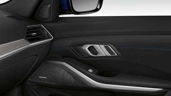 BMW 3 Series Sedan, Harman Kardon surround sound system. Close-up of the inner passenger door illuminated with built-in speaker of the Harman Kardon surround sound system.