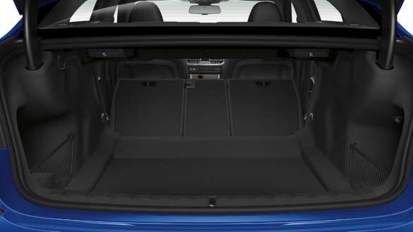 BMW 3 Series Sedan, trough-loading system Close-up of the opened trunk with the rear backseats half folded down.