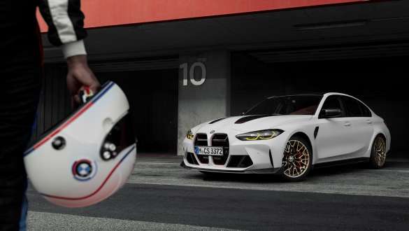 CS specific Driving Dynamics Package BMW M3 CS G80 BMW M3 CS G80 CS specific Driving Dynamics Package Person with BMW helmet in hand and BMW M3 CS standing in background