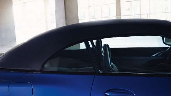 Softtop BMW M4 Competition Cabriolet with M xDrive G83 2021 BMW M4 Competition Cabriolet with M xDrive G83 2021 BMW Individual Frozen Portimao Blue metallic with closed softtop and man in front