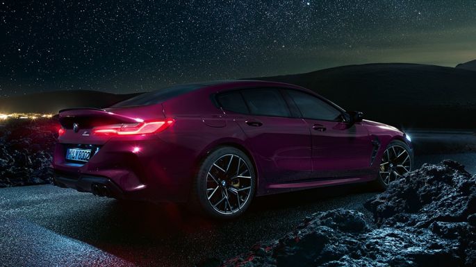 BMW M8 Competition Gran Coupé three-quarter side view from rear BMW M8 Competition Gran Coupé 2020 Ametrine metallic side view at night.