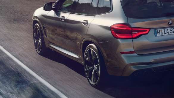 BMW X3 M Competition, three-quarter rear view. BMW X3 M Competition in Donington Grey metallic, exterior, three-quarter front view, M specific suspension.