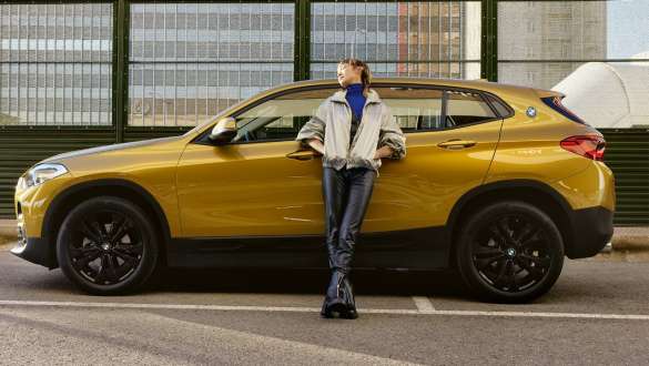 BMW Service Inclusive for used cars BMW Service Inclusive woman leans on BMW X2