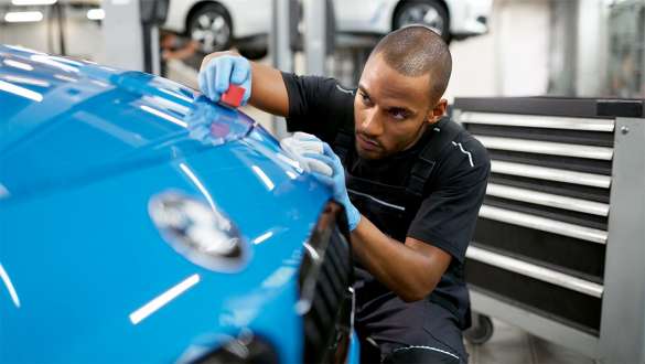BMW specialist is polishing car BMW Repair & Care BMW specialist is polishing car