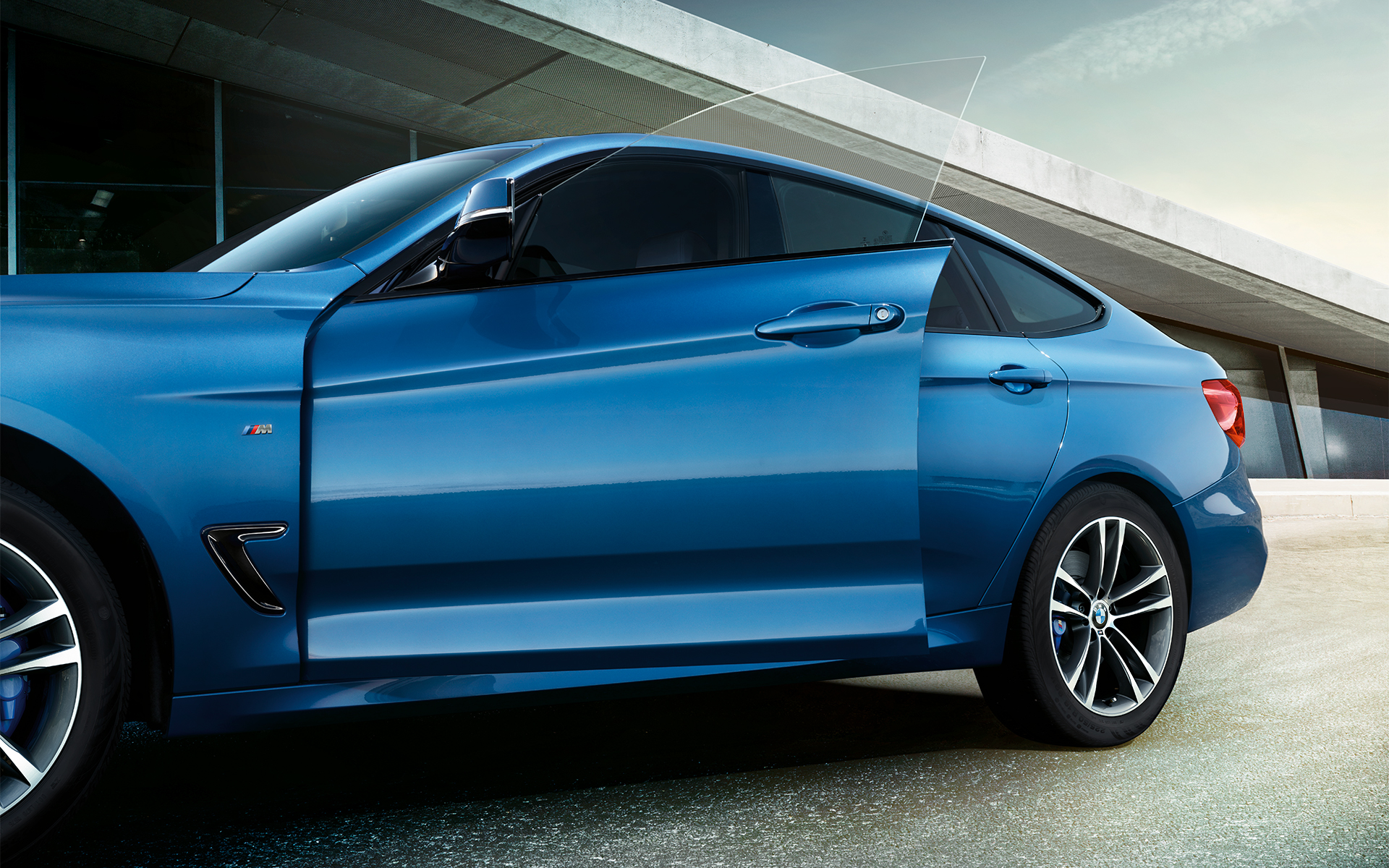 BMW 3 Series Gran Turismo open front door in bright blue color. BMW 3 Series Gran Turismo open front door in bright blue color.