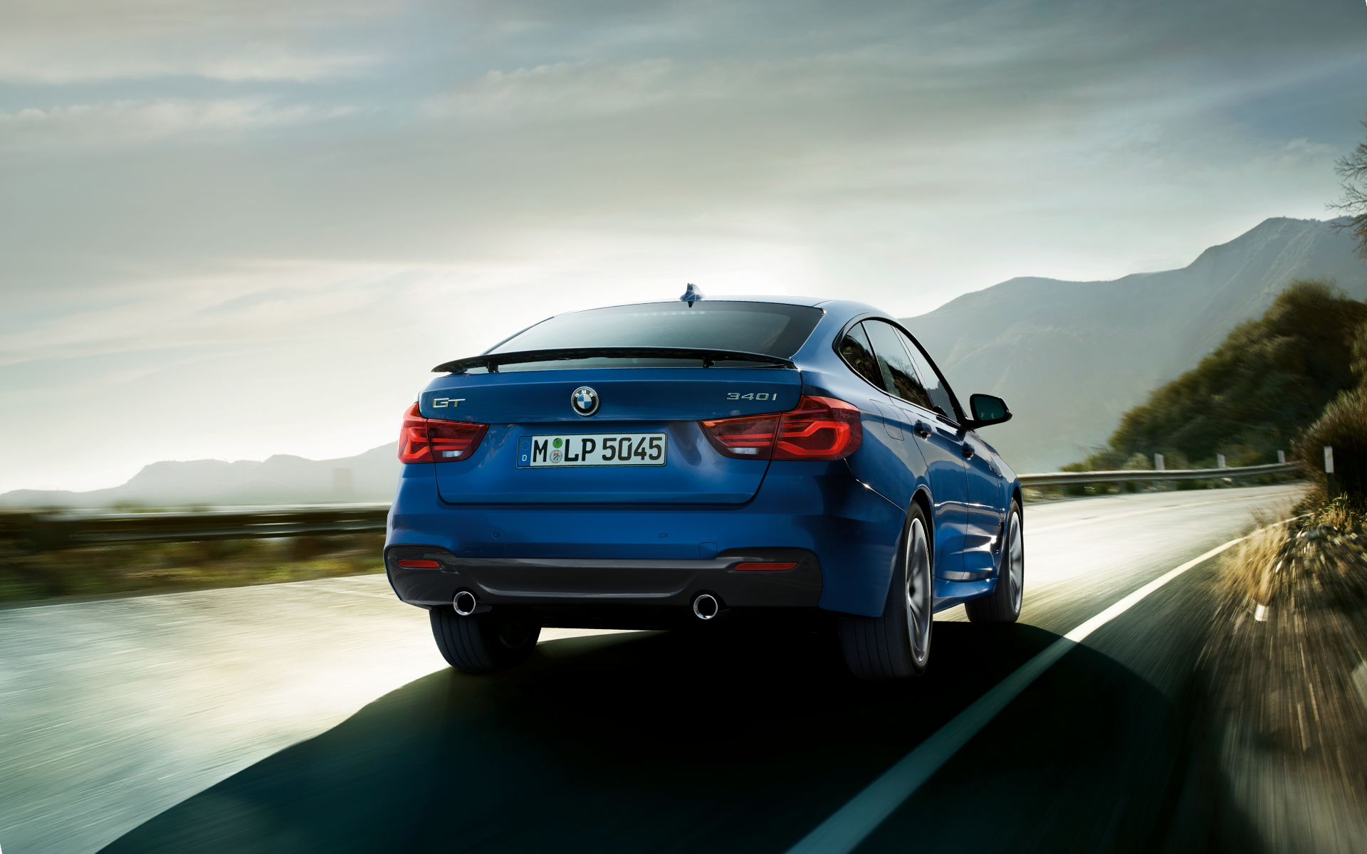 BMW 3 Series Gran Turismo: rear blue vehicle driving with aspiring views. BMW 3 Series Gran Turismo: rear blue vehicle driving with aspiring views.
