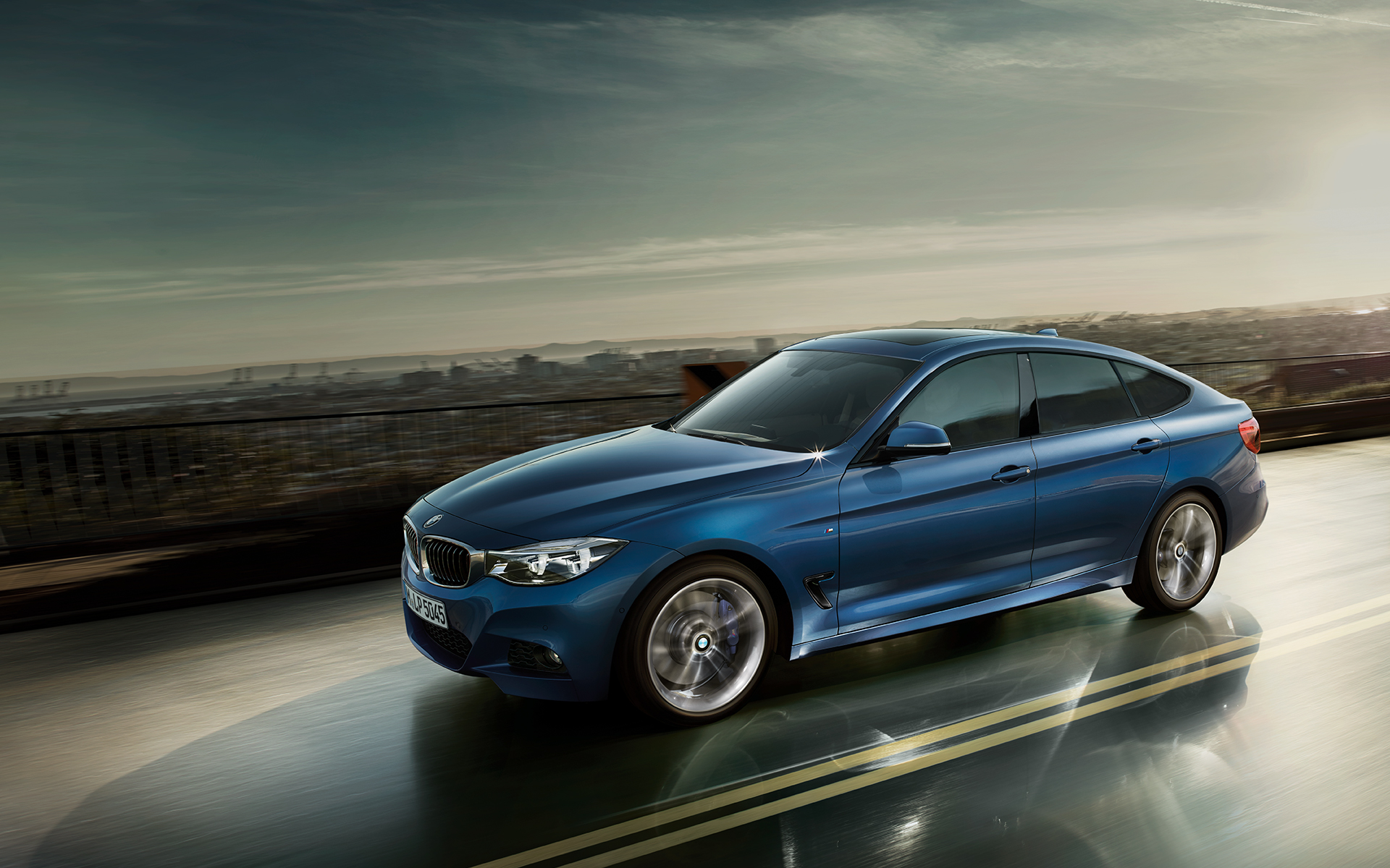 BMW 3 Series Gran Turismo - side view city driving. BMW 3 Series Gran Turismo - side view city driving.