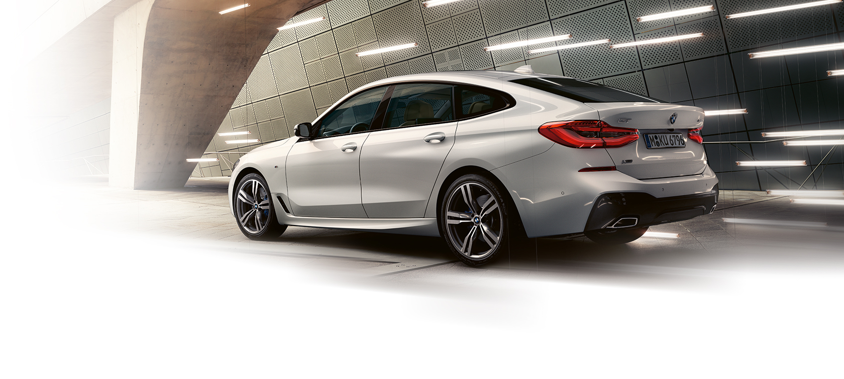 BMW 6 Series Gran Turismo: metallic rear view car parked under bridge. BMW 6 Series Gran Turismo: metallic rear view car parked under bridge.