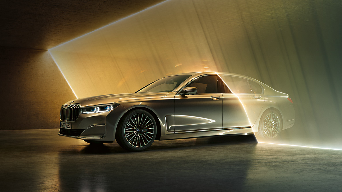 BMW 7 Series Sedan in three-quarter front view BMW 7 Series Sedan: grey BMW in three-quarter front view surrounded by beam of light