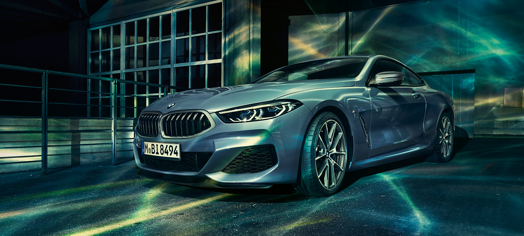 BMW 8 series, driving A driving shot of the BMW 8 Series Coupé at night and in an urban setting.
