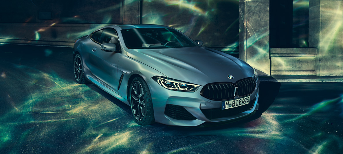 Vue de trois quarts face de la BMW M850i Coupé First Edition La BMW M850i Coupé First Edition, vue de trois quarts face devant un décor urbain.