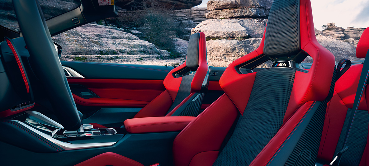 BMW Individual full leather trim 'Merino' Fiona Red/Black BMW M4 Competition Cabriolet with M xDrive G83 2021 BMW Individual full leather trim 'Merino' Fiona Red/Black BMW M4 Competition Cabriolet with M xDrive G83 2021 interior side view with open softtop