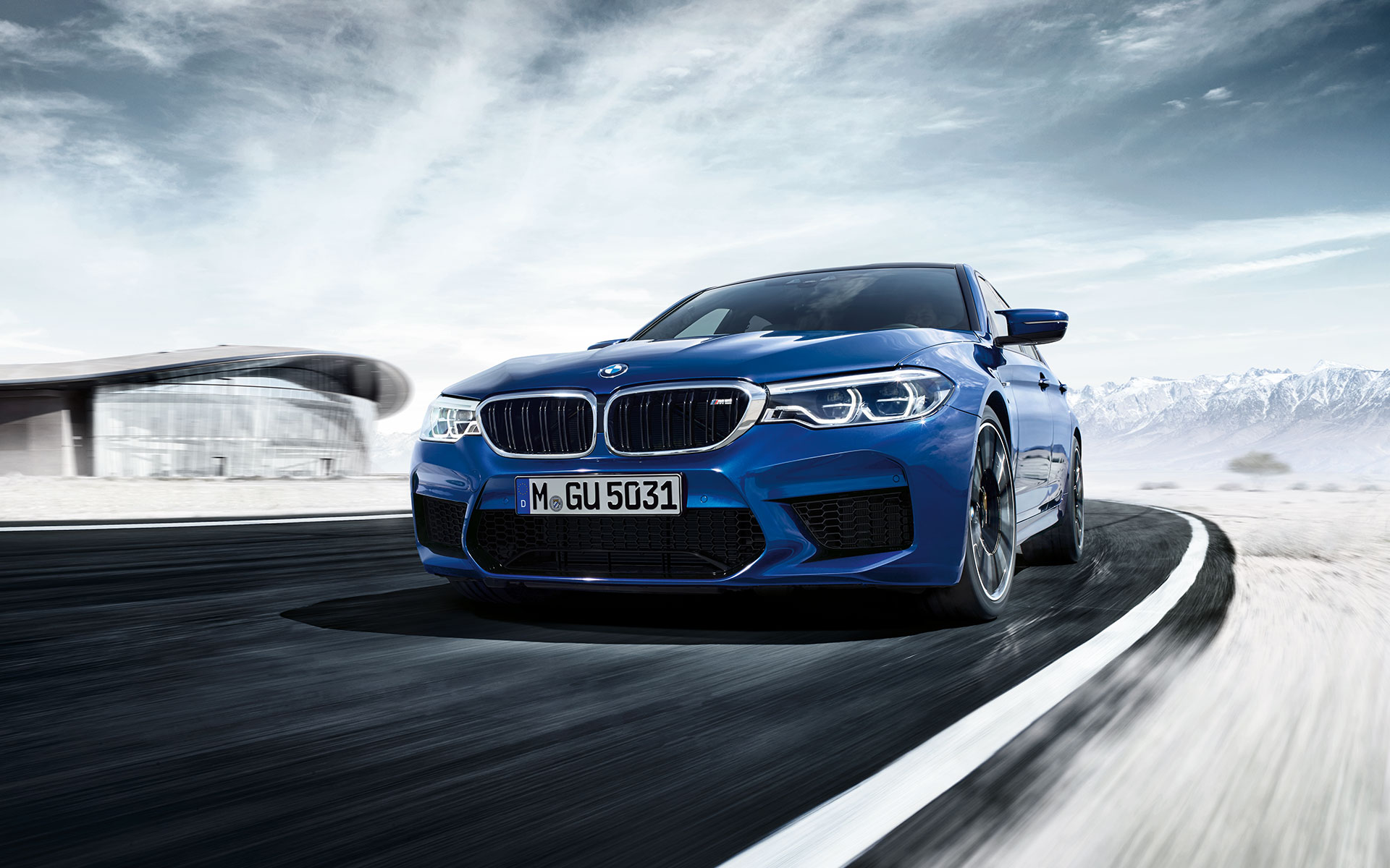 BMW M Series M5 Sedan: bright blue, high-performance car. BMW M Series M5 Sedan: bright blue, high-performance car.