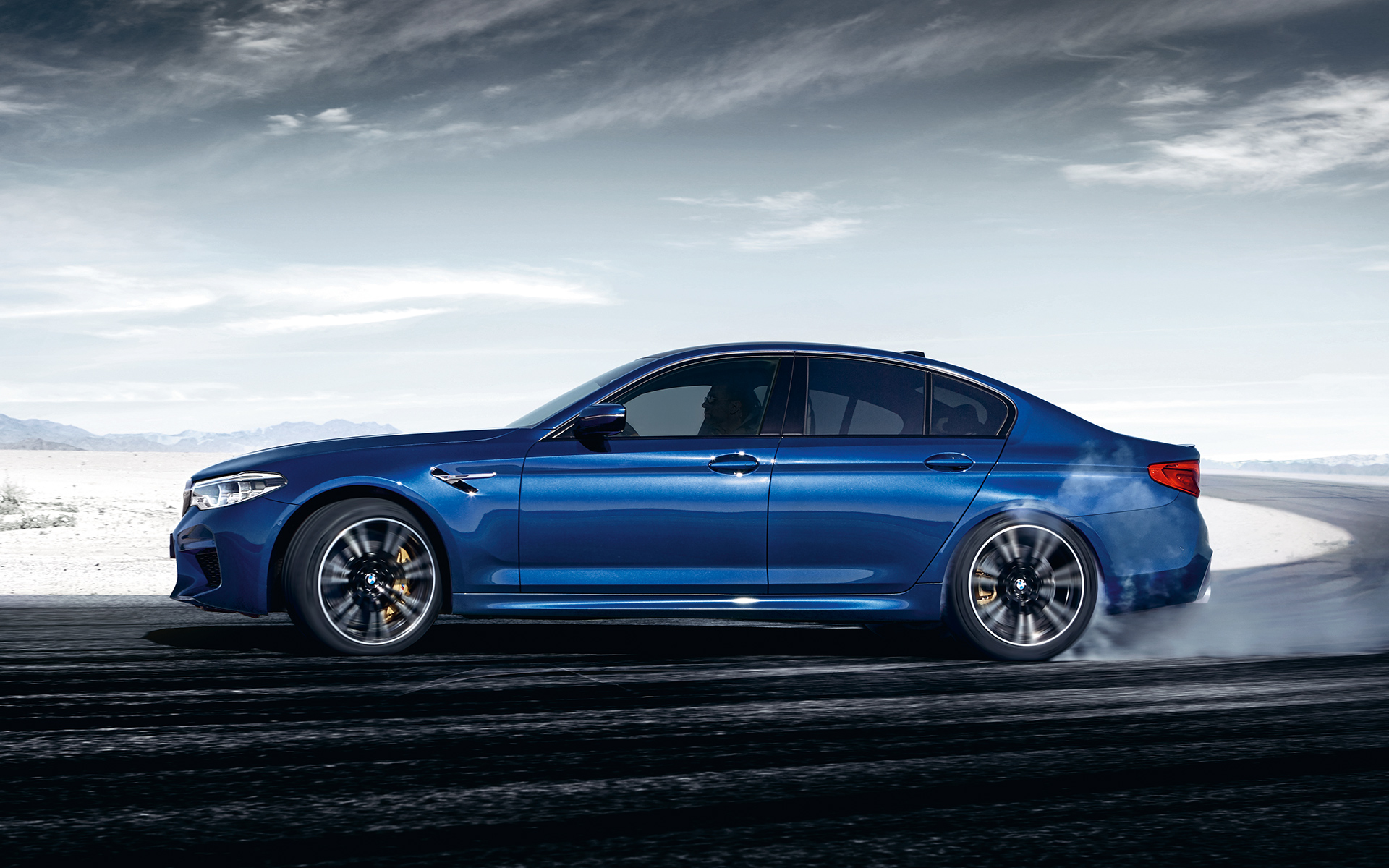 BMW M Series M5 Sedan: side view of bright blue car. BMW M Series M5 Sedan: side view of bright blue car.