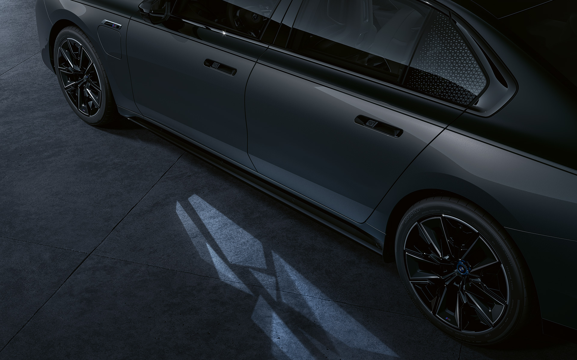 Lightning concept BMW M760e xDrive Sedan G70 Lightning concept BMW M760e xDrive Sedan G70 BMW Individual two-tone Black Sapphire metallic paintwork BMW Individual Dravite Grey metallic side view close-up with Welcome Light Carpet on