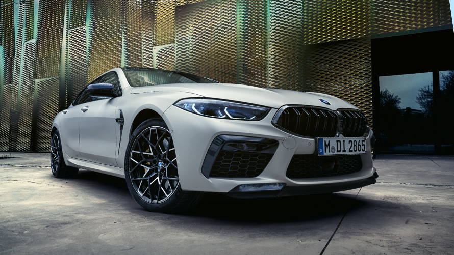 The new BMW M8 Competition Gran Coupé F93 LCI Facelift 2022 BMW Individual Frozen Brilliant White metallic three-quarter front view low-angle shot