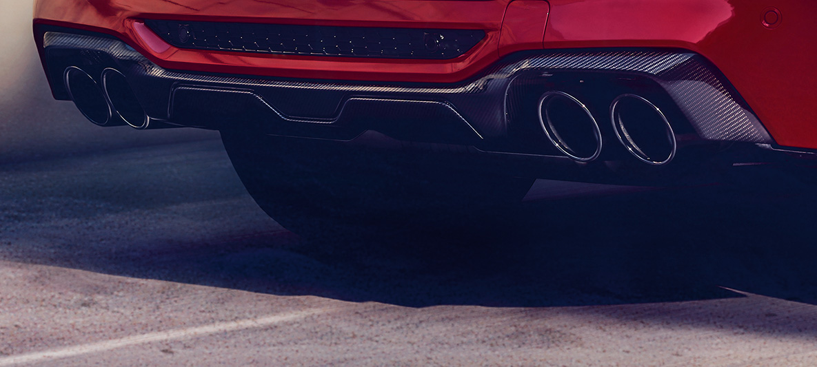BMW X4 M Competition, rear diffusor in carbon. BMW X4 M Competition in Toronto Red metallic, exterior, M Carbon exterior package, rear diffusor in carbon.