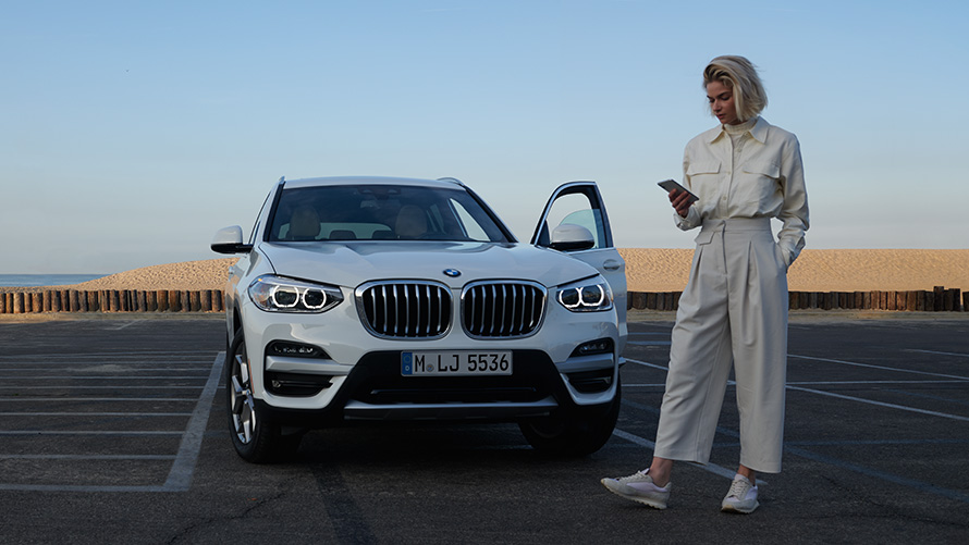 BMW X3 G01 SUV Brochure App woman next to BMW 2021 BMW X3 G01 SUV Brochure App 2021