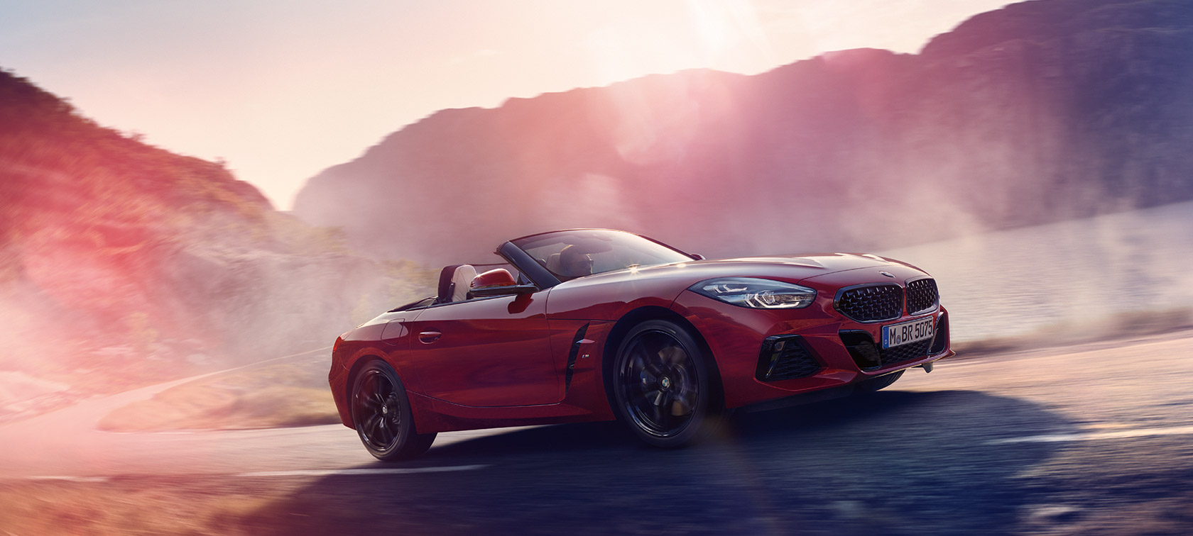 BMW Z Series Roadster: driving uphill in convertible red car. BMW Z Series Roadster: driving uphill in convertible red car.