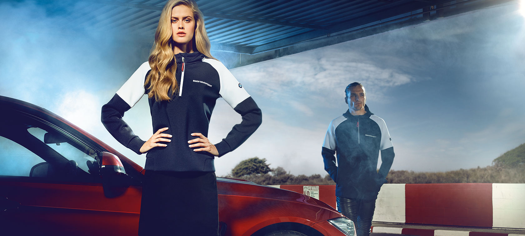 Man and woman in BMW Motorsport Collection clothing. Man and woman in BMW Motorsport Collection clothing.
