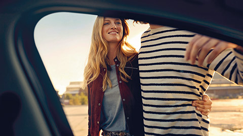 BMW Financial Services man and woman photographed through car window of a BMW