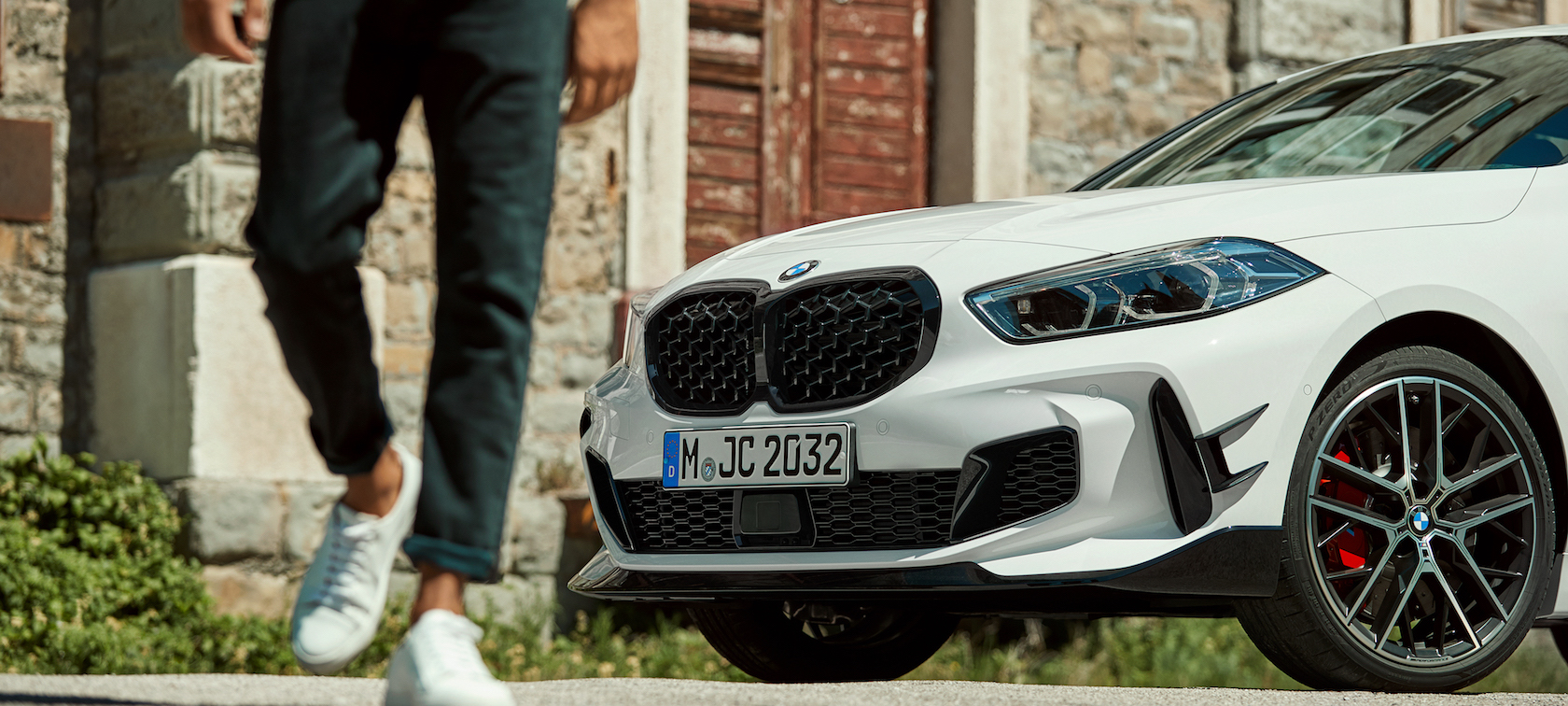 A man walks away from his BMW vehicle A man walks away from his BMW vehicle