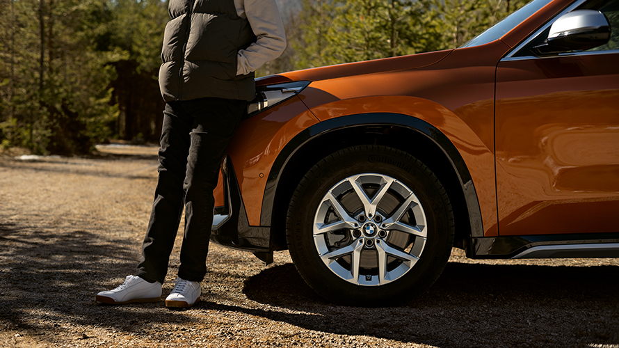 Man leaning on  his BMW