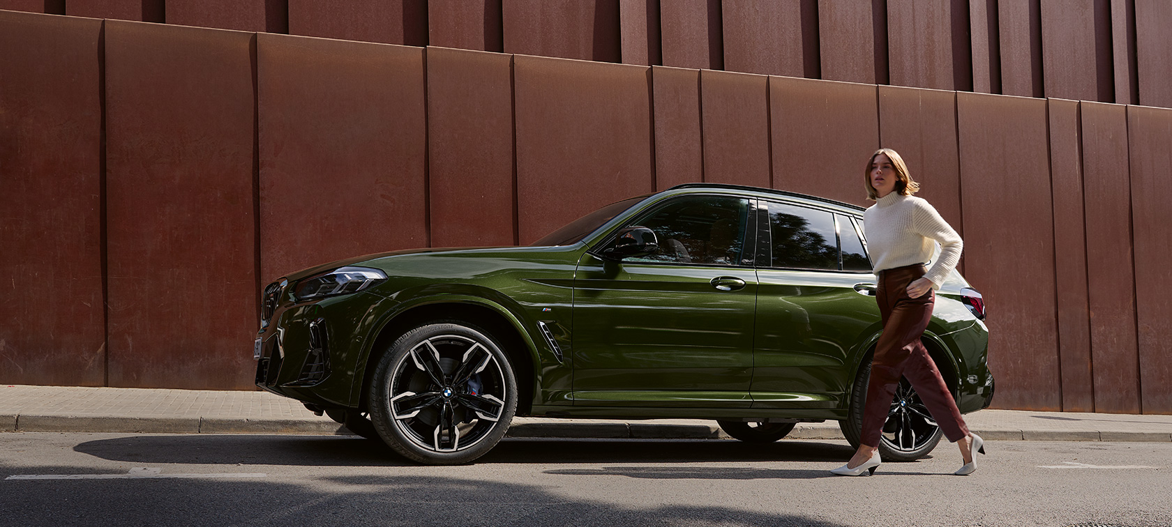 Woman standing at the door of a BMW X3M