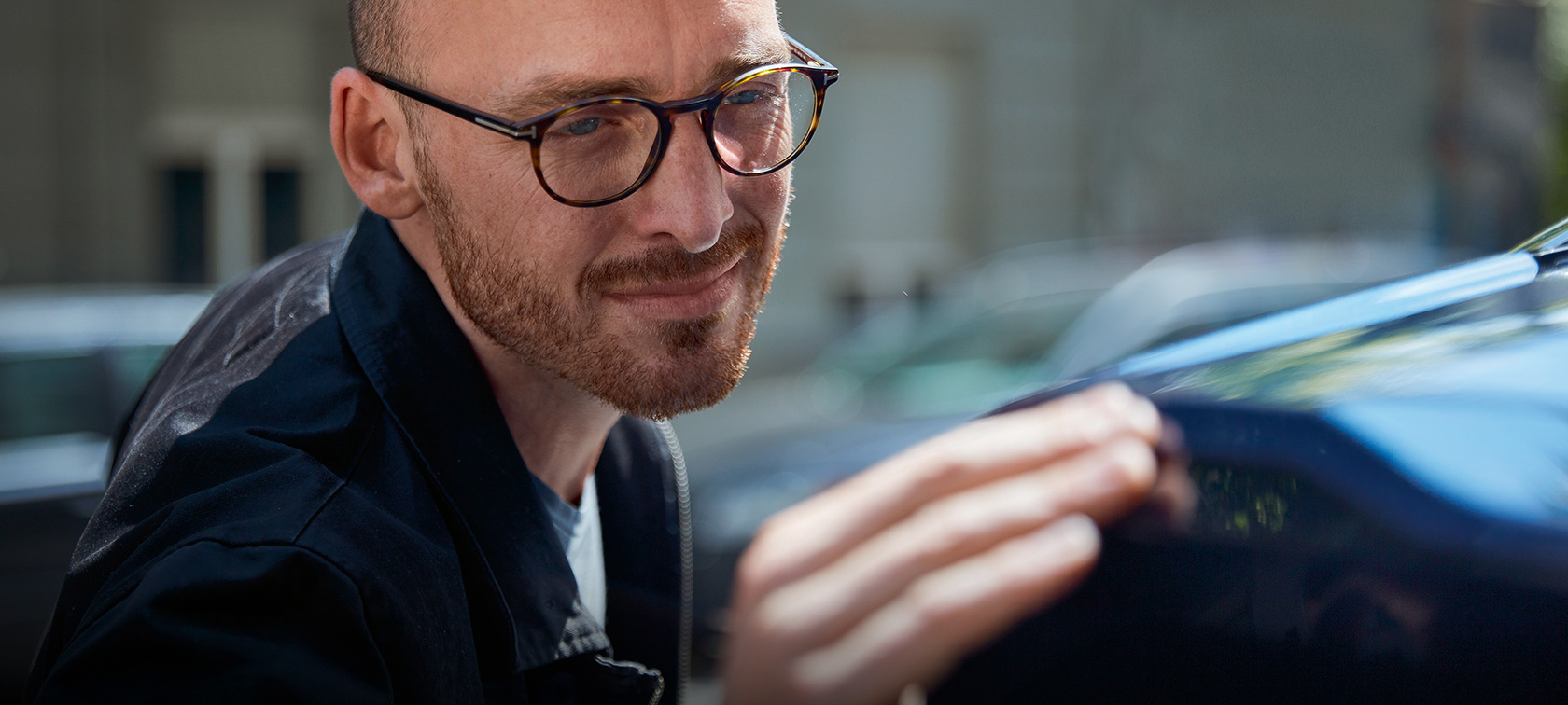 Man standing beside a BMW