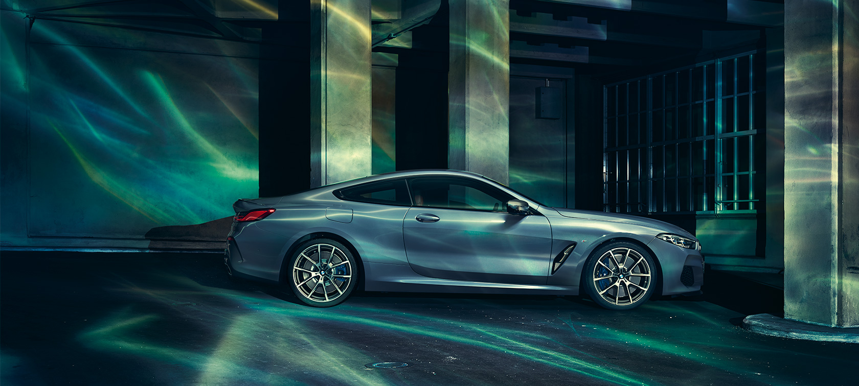 La BMW Série 8, en mouvement. La BMW Série 8 Coupé photographiée de nuit, roulant dans un décor urbain.