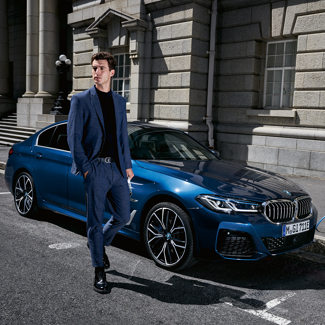 man walking beside car man walking beside car