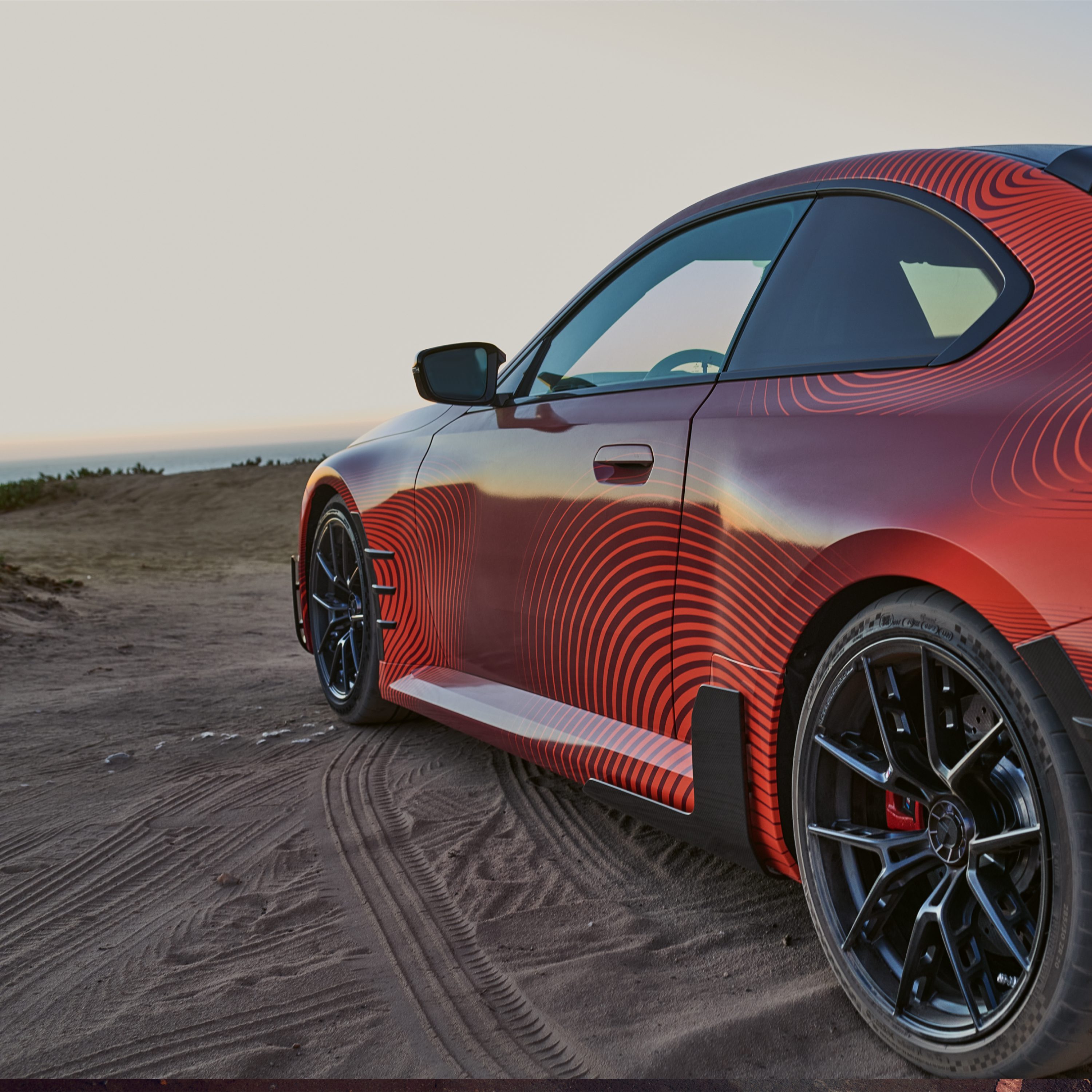 BMW with M Performance Parts standing on the beach