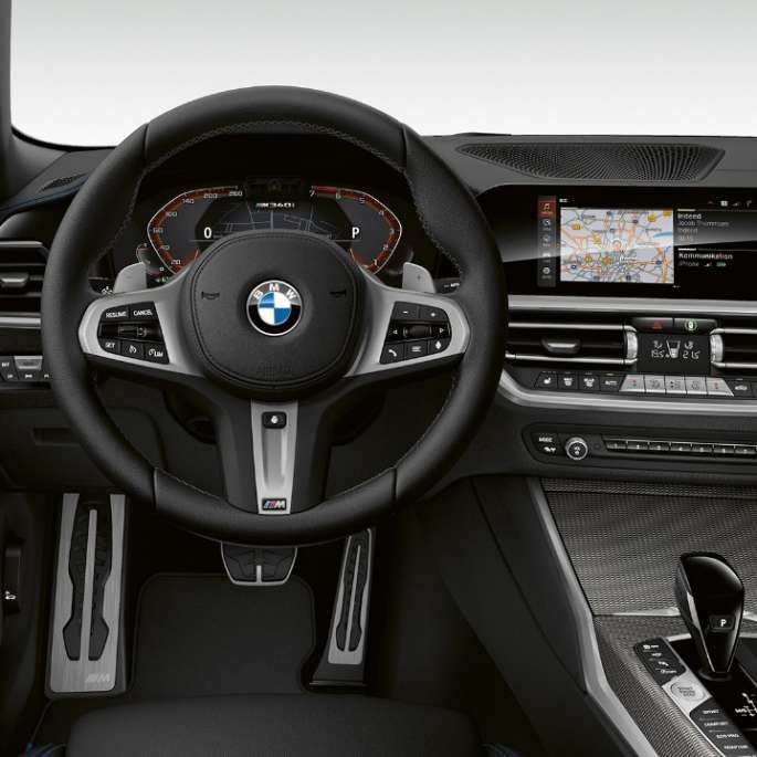Frontal close-up of the driver's cockpit of the BMW 3 Series M340i xDrive Sedan.