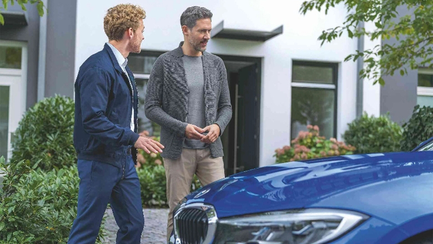 Two men looking at BMW