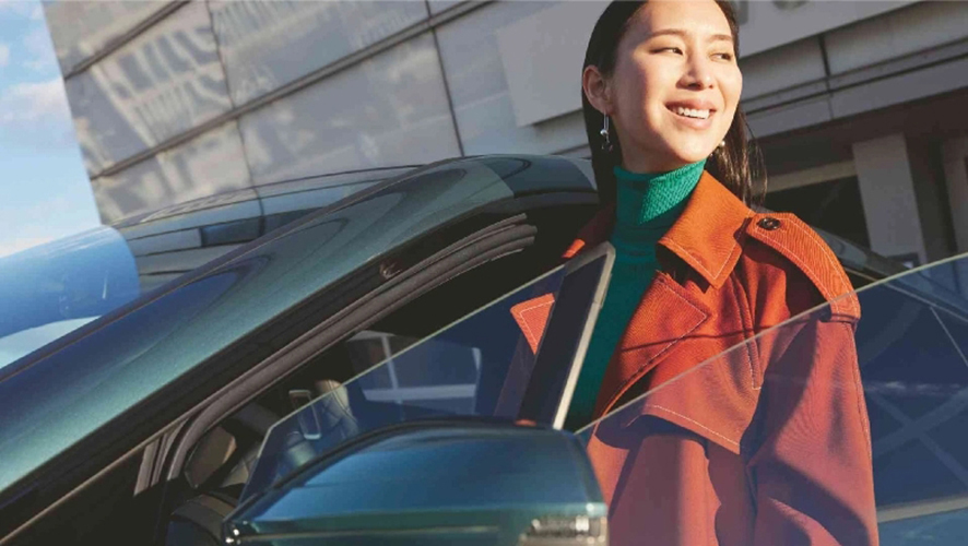 Woman walking away from BMW.